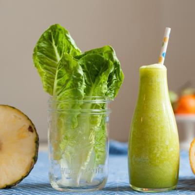Green smoothies recipes for beginners with pineapple, orange and romaine lettuce.