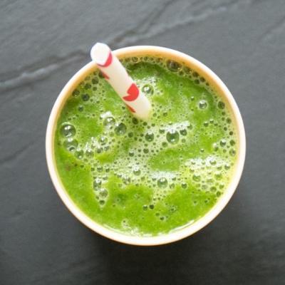 Green smoothie garnished with cherry blossoms
